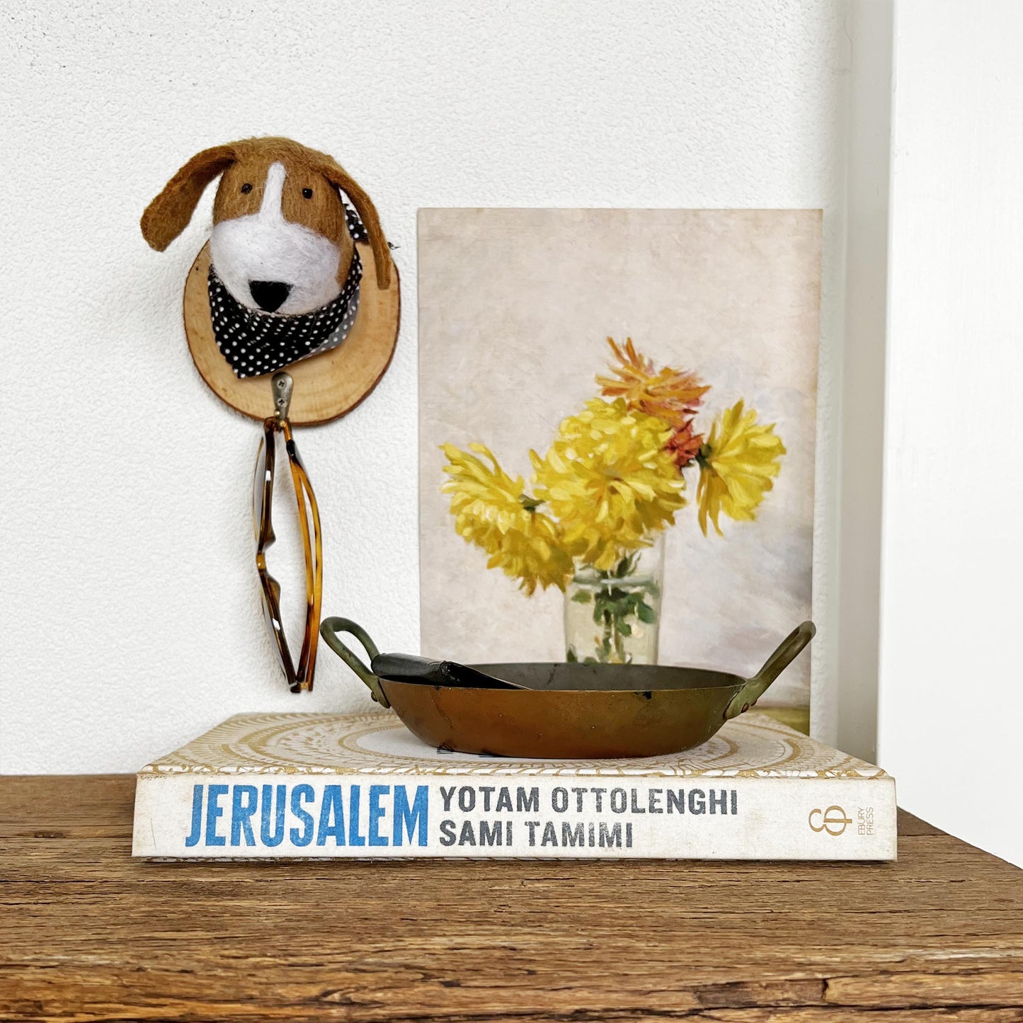 Hand-felted dog hook holding sunglasses