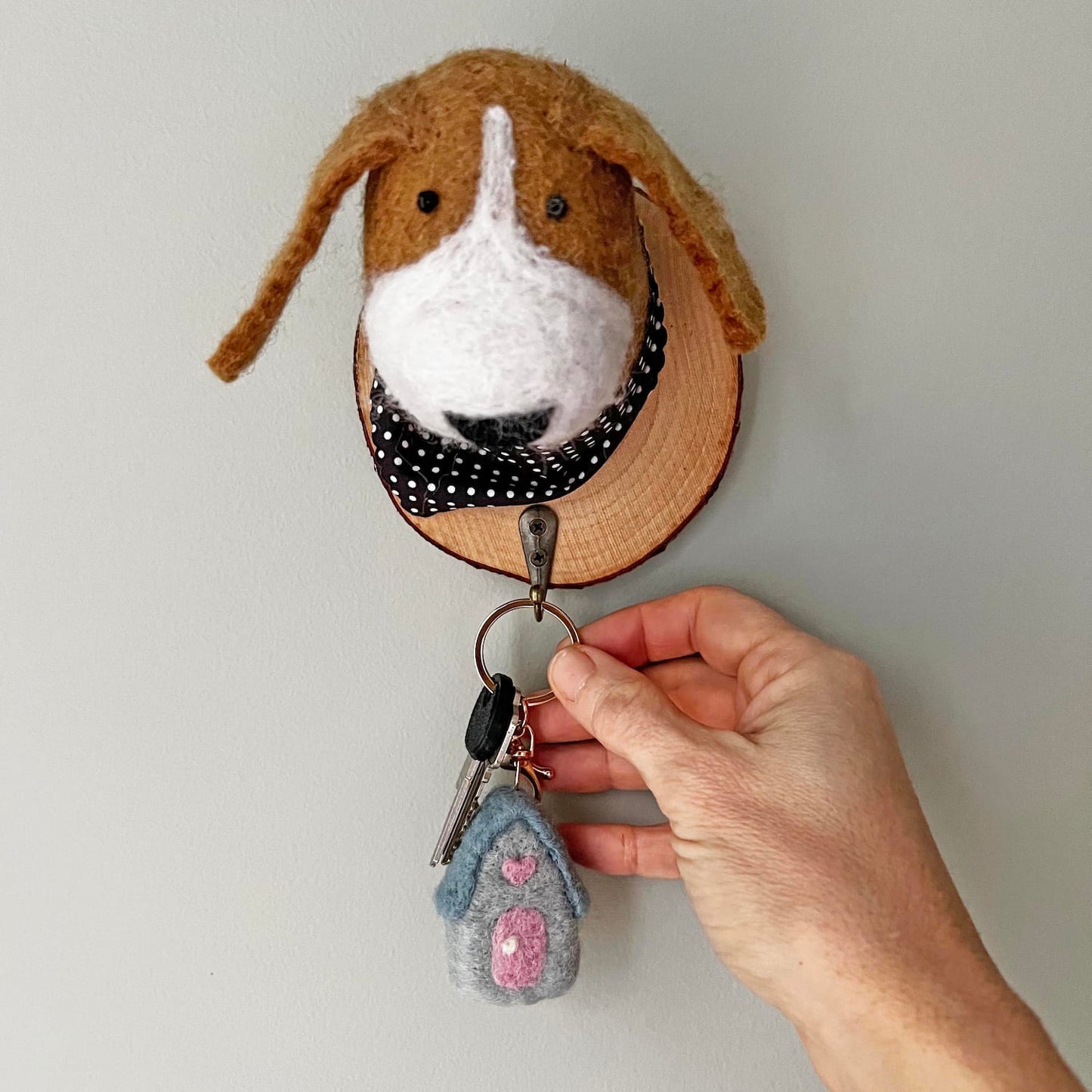 Fair trade felt house keychain hanging on dog wall hook