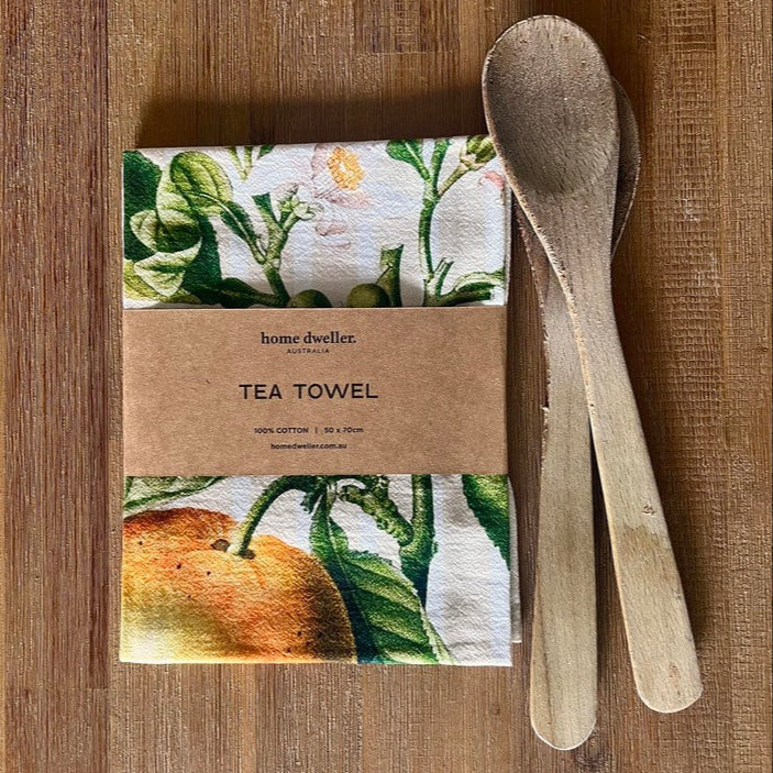 Vintage style orange art tea towel folded on kitchen bench