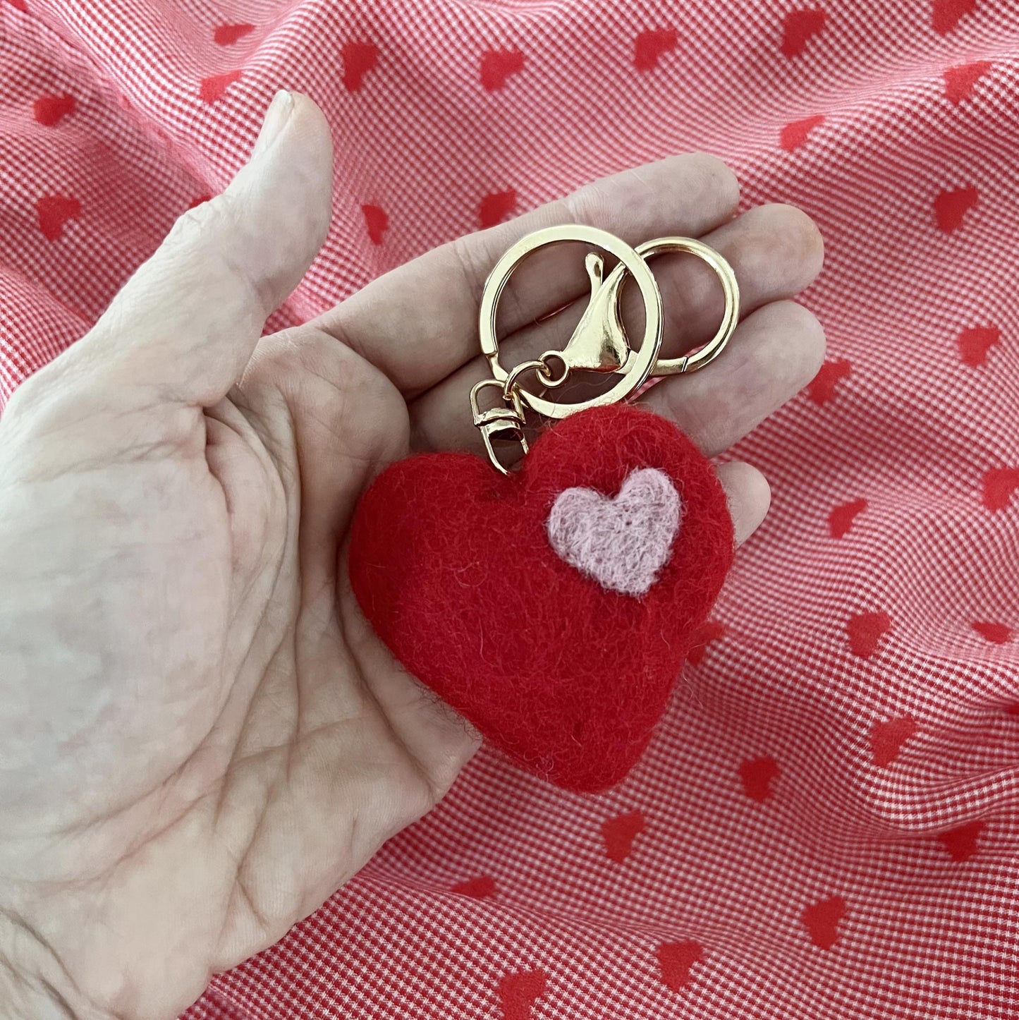 Close-up of handmade felt heart charm keyring