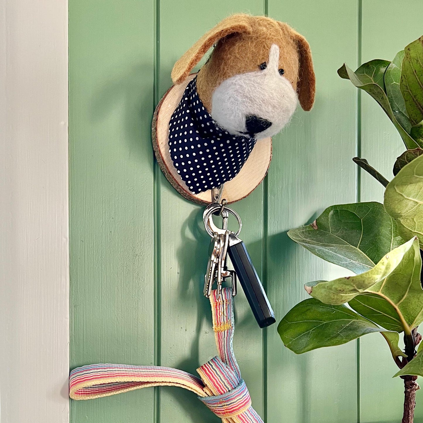 Dog wall hook holding dog leash and keys