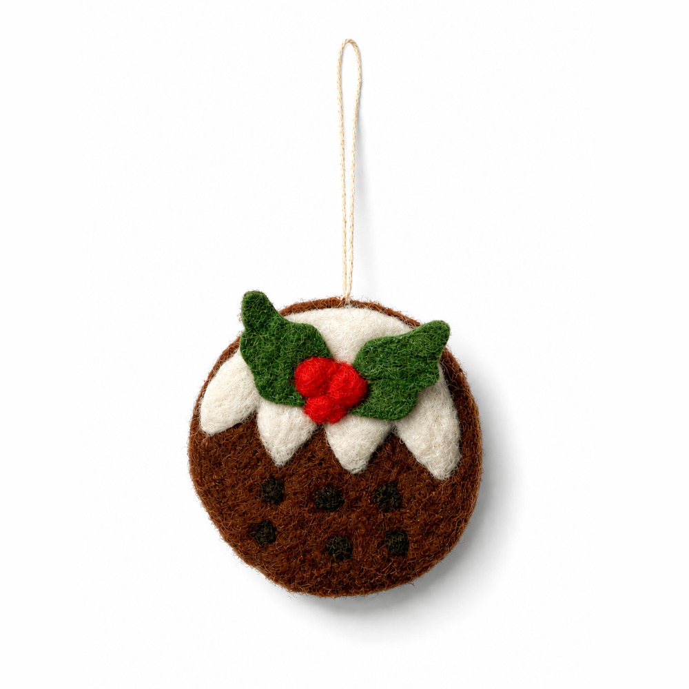 A felt Christmas pudding ornament hanging from a natural jute string, featuring brown wool, white frosting, green holly leaves, and a red berry accent on a white background.