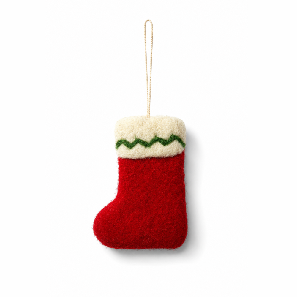 A small felt Christmas stocking ornament in red with a cream cuff and a green zigzag stripe, hanging by a thin cream string on a white background.
