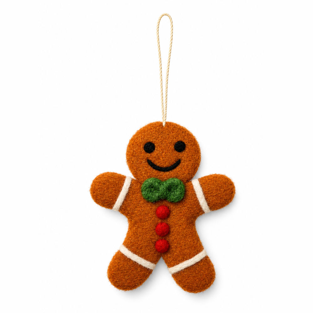 A felt gingerbread man Christmas ornament with a green bow tie, red buttons, and white trim, hanging from a beige string on a white background.
