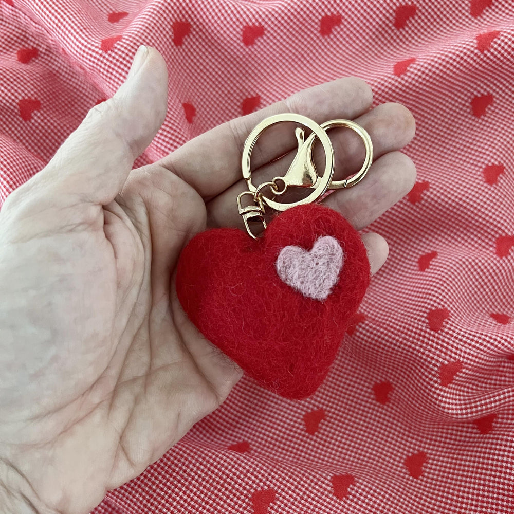 
                  
                    Close-up of handmade felt heart charm keyring
                  
                
